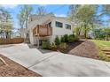 Exterior home featuring a driveway, upper deck, and landscaping at 2870 Ridgemore Nw Rd, Atlanta, GA 30318