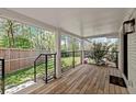 Covered back porch with wooden flooring and views of the backyard at 2870 Ridgemore Nw Rd, Atlanta, GA 30318