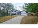 Attractive home featuring well-maintained lawn, long driveway, and a welcoming facade at 1960 Calvin Dr, Duluth, GA 30097