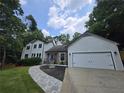 Charming stucco home featuring an attached garage, manicured landscaping, and a winding paver walkway at 1960 Calvin Dr, Duluth, GA 30097