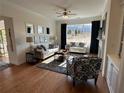 Spacious living room featuring hardwood floors, comfortable seating, and bright, natural light at 1702 Bonica Xing # 1702, Cumming, GA 30040
