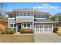 Beautiful home with a well-manicured lawn, gray siding, white trim, and an attached two-car garage at 1903 River Birch Ln, Atlanta, GA 30316