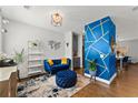Inviting living room featuring stylish decor, a cozy blue sofa, and unique geometric wall accents at 1903 River Birch Ln, Atlanta, GA 30316
