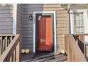 Charming front door with holiday pumpkins, gray siding, and a black framed screen door at 7020 at 7020 Panda Ln, Austell, GA 30168