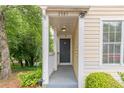 Close-up of a cozy front porch with a black front door and overhead lighting at 3987 Bayside Cir, Atlanta, GA 30340