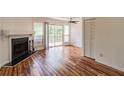 Bright living room featuring hardwood floors, a fireplace, and sliding glass doors to the deck at 3987 Bayside Cir, Atlanta, GA 30340