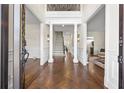 Grand foyer features a herringbone floor, staircase, and elegant columns at 4620 Chattahoochee Se Xing, Marietta, GA 30067