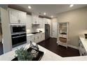 Modern kitchen featuring stainless steel appliances, white cabinets, and quartz countertops at 1601 Bonica Xing # 1601, Cumming, GA 30040