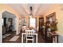 Dining room features modern light fixture, paneled walls, and wood-look floors at 177 Carolyn Se Ct, Acworth, GA 30101