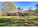 Single-story home with green yard, red shutters, and front deck at 177 Carolyn Se Ct, Acworth, GA 30101