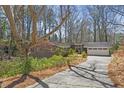 Charming home nestled among mature trees with a long driveway and a two-car garage at 2724 Janellen Dr, Atlanta, GA 30345