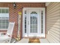 A cozy front porch featuring brick accents, a rocking chair, and a decorative welcome sign at 4145 Alveston Dr, Atlanta, GA 30349