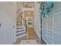 Bright foyer features hardwood floors, wainscotting, staircase, and an open view to the second floor at 1098 Central Park Rd, Decatur, GA 30033