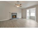 Bright living room featuring a fireplace, a large window bay and stylish gray flooring at 2463 Corner Shoals Dr, Decatur, GA 30034