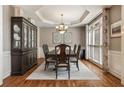 Elegant dining room featuring a large wooden table, chandelier, and a decorative china cabinet at 4249 Millside Walk, Smyrna, GA 30080