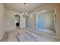 Bright dining room with hardwood floors, a chandelier, and open doorways leading to other rooms at 5863 Little River Rd, Atlanta, GA 30349