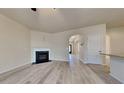 Cozy living room with hardwood floors, fireplace, and open access to dining and kitchen areas at 5863 Little River Rd, Atlanta, GA 30349