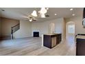 Spacious living space featuring hardwood floors, a fireplace, open kitchen, and staircase at 5863 Little River Rd, Atlanta, GA 30349