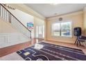 Bright entryway features hardwood floors, staircase, and large window providing natural light at 7514 Absinth Dr Pass, Atlanta, GA 30349