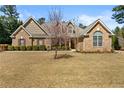Attractive brick home with a well-maintained lawn and blooming tree in the front yard at 79 Tiffany Trce, Palmetto, GA 30268