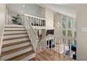 The staircase leads to a spacious living area with large windows providing ample natural light at 1720 Little Willeo Rd, Marietta, GA 30068