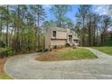 This home features lush greenery and a winding driveway leading to the beautiful exterior at 1720 Little Willeo Rd, Marietta, GA 30068