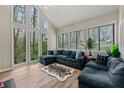 Bright living room with large windows and a cozy seating area, offering serene views of the outdoors at 1720 Little Willeo Rd, Marietta, GA 30068