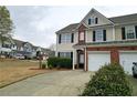 Charming townhome with manicured front yard, driveway, and convenient garage access at 3615 Hutchinson Trace Dr, Cumming, GA 30040