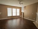 Spacious living room featuring hardwood floors, ample natural light, and a ceiling fan at 3615 Hutchinson Trace Dr, Cumming, GA 30040