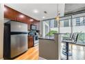 Modern kitchen with stainless steel appliances, breakfast bar, and city view from the large windows at 44 Peachtree Nw Pl # 629, Atlanta, GA 30309