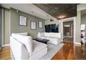 Comfortable living room featuring stylish decor, hardwood floors, and an open doorway to the bedroom at 44 Peachtree Nw Pl # 629, Atlanta, GA 30309