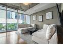 Sunny living room with large windows, city views, and modern decor for comfortable living at 44 Peachtree Nw Pl # 629, Atlanta, GA 30309