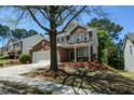 Charming brick home with two-car garage, manicured yard, mature shade trees, and great curb appeal at 5660 Sable Bay Pt, Atlanta, GA 30349