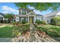 Inviting two-story home with a manicured lawn, lovely landscaping, and a welcoming yellow front door at 429 Argonne Ter, Canton, GA 30115