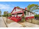 Charming home with white and red exterior, awning, landscaped front yard, and fenced yard at 814 Welch Sw St, Atlanta, GA 30310