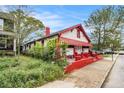 Charming home with white and red exterior, awning, and landscaped front yard at 814 Welch Sw St, Atlanta, GA 30310