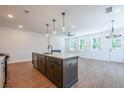 Modern kitchen with stainless steel appliances, island, and open to a bright living area at 1600 Ruskin Way, Marietta, GA 30062