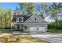 Charming home with a two-car garage, inviting front porch, and manicured lawn at 2442 Lower Union Hill Rd, Canton, GA 30115
