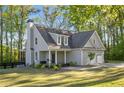 Beautiful home with an attached two-car garage and a cozy front porch at 2442 Lower Union Hill Rd, Canton, GA 30115