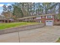 Well-maintained home with a two-car garage, a front porch, and a concrete retaining wall at 3441 Palace Ct, Tucker, GA 30084