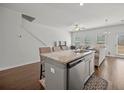 Open kitchen with granite countertops and stainless steel appliances flowing into the living area at 7083 Gladstone Cir, Stonecrest, GA 30038