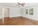 Bright living room featuring hardwood floors, neutral paint, white trim, and an updated ceiling fan at 353 Oak Ridge Se Dr, Marietta, GA 30060