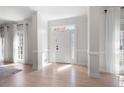 Bright foyer with hardwood floors, elegant trim, and a front door with decorative glass inserts at 966 Laurel Springs Sw Ln, Marietta, GA 30064