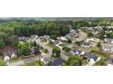 Aerial view of a residential neighborhood showcasing tree-lined streets and well-maintained homes at 2650 Hamilton Chase Run, Buford, GA 30519