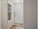 Bright entryway with laminate floors, a front door, and a window at 409 Natchez Trce, Sandy Springs, GA 30350