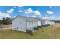 Rear view of townhouses showing exteriors, new lawn and fencing on a sunny day at 52 Leggett Dr # 183, Villa Rica, GA 30180