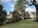 Beautiful brick home with well-kept lawn and mature trees at 1514 Haven Crest Dr, Powder Springs, GA 30127