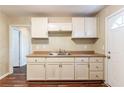 Functional kitchen featuring wood-look floor, laminate countertops, and ample cabinet space at 1951 Brannen Se Rd, Atlanta, GA 30316