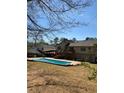 Backyard featuring a refreshing in-ground pool and deck, great for enjoying warm days and outdoor living at 321 Roses Creek Dr, Lawrenceville, GA 30044