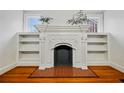 Elegant fireplace with decorative mantle and flanking built-in shelves at 1420 Elizabeth Ln, East Point, GA 30344